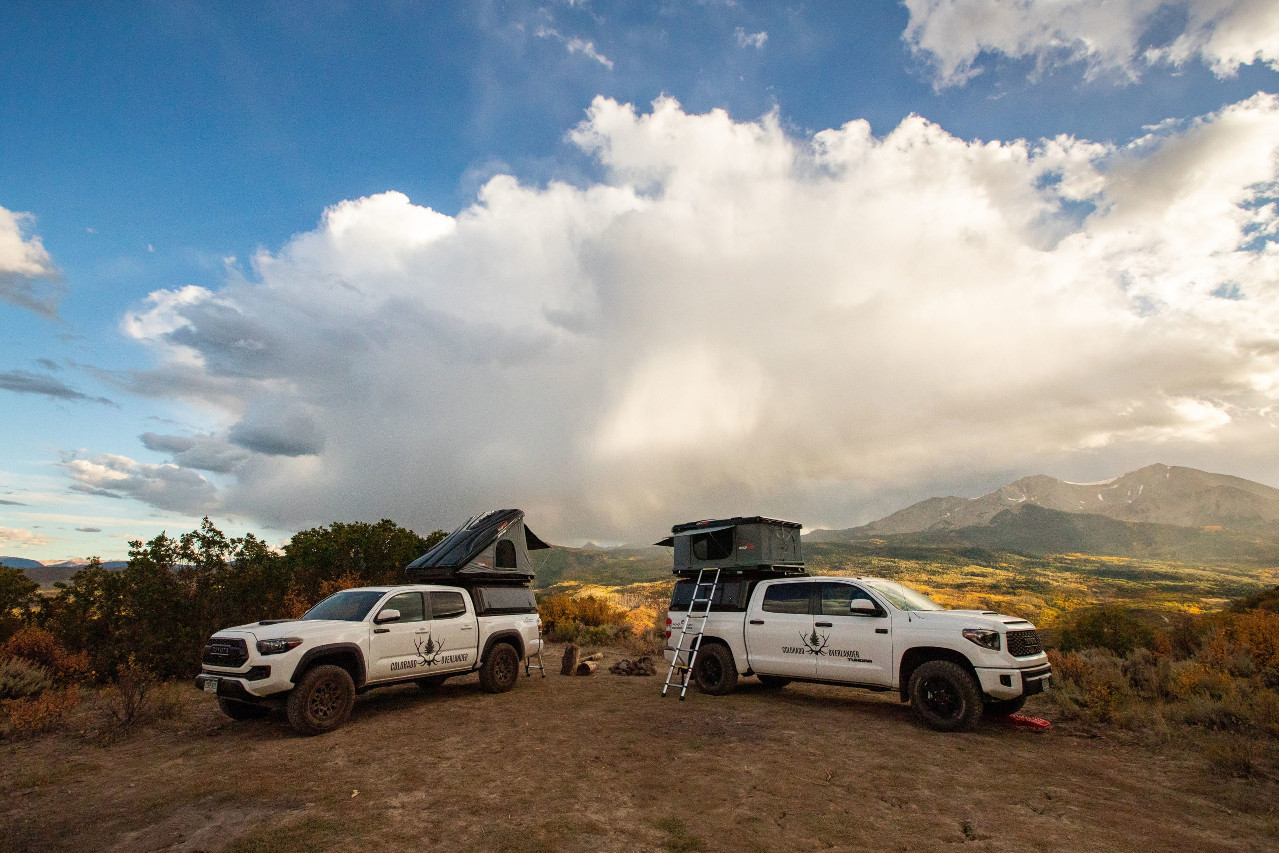 Image of a Colorado Overlander Toyota Tundra TRD Pro and Toyota Tacoma TRD Pro with both roof nests popped open with stunning mountain views in the background