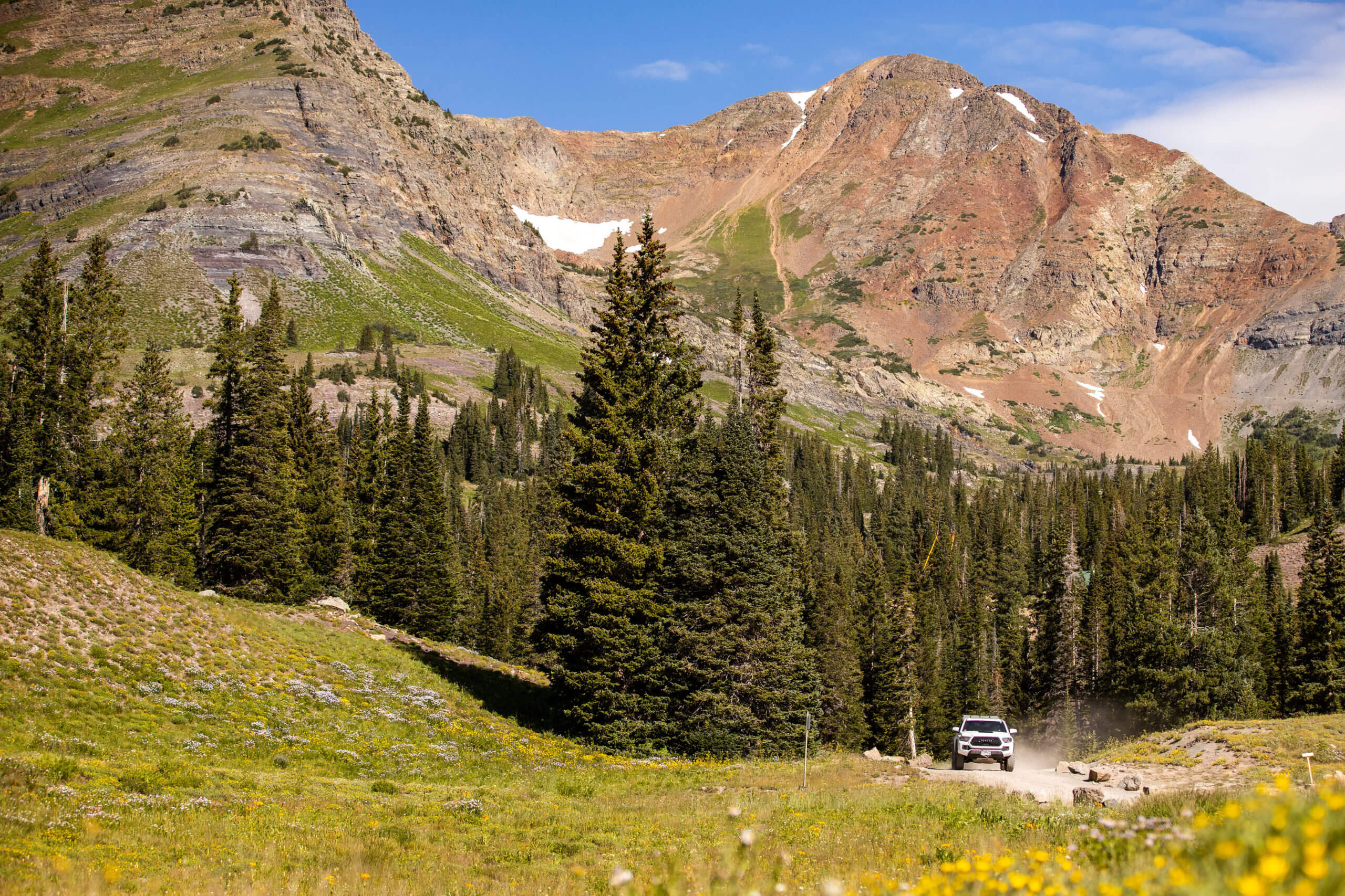 Image of a Colorado Overlander vehicle driving in front of dramatic mountains