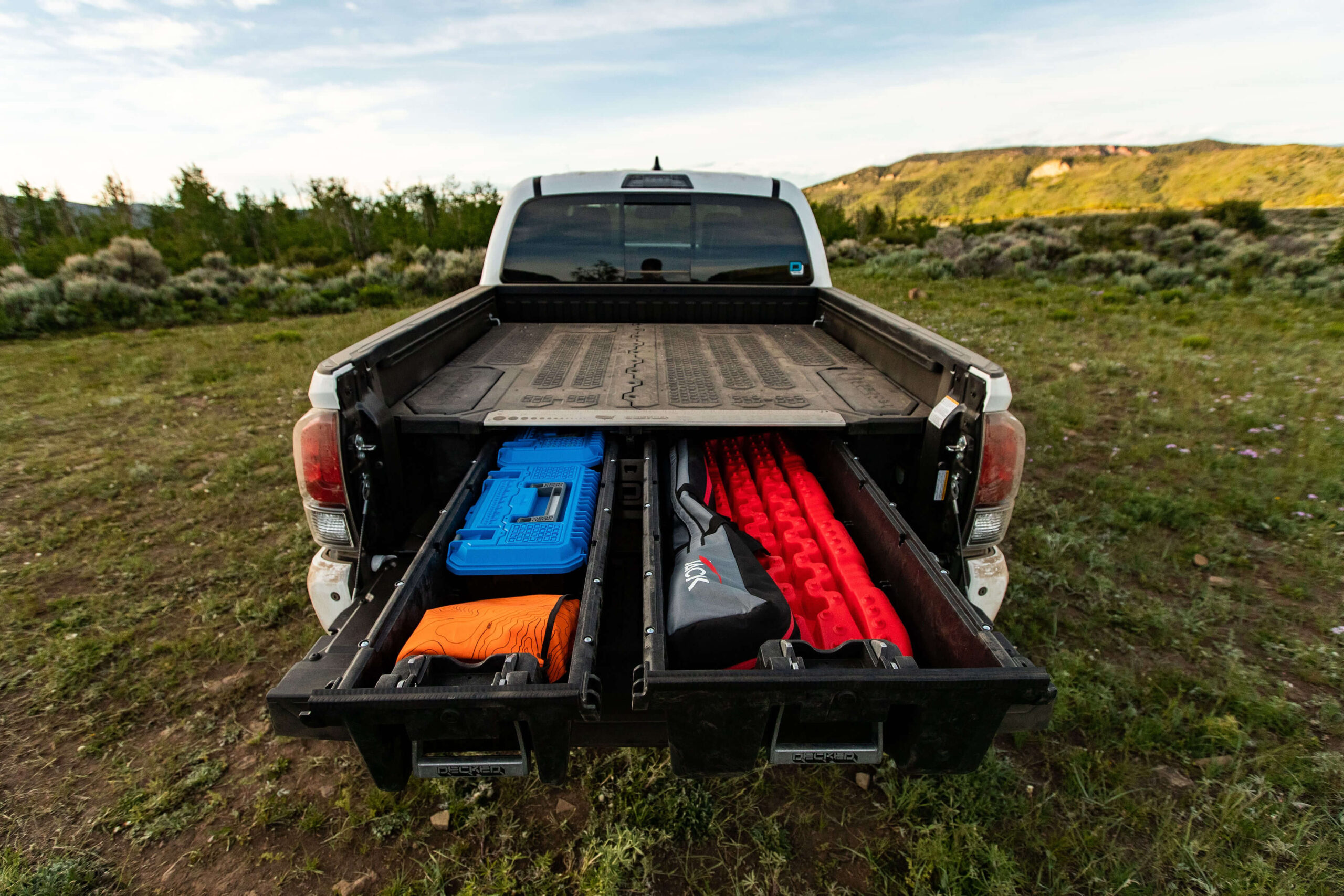 Image of a Toyota Tacoma and it's Decked drawer system open exposing the gear in the drawer