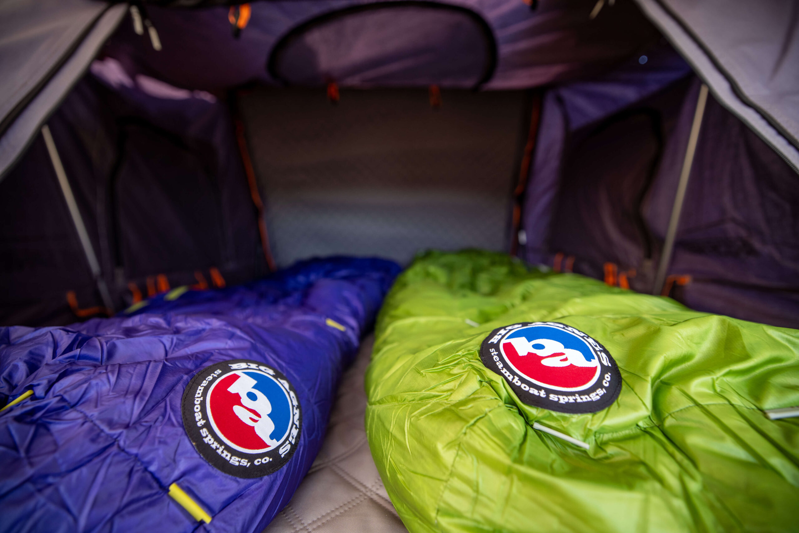 Image of two sleeping bags in a rooftop tent